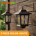 Set of 2 Solar-Powered Wall Lanterns, Designed for Outdoor Use, Featuring 4 Solar Panels, LED Lights That Operate from Dusk Till Dawn, Rust-Resistant And Waterproof with Hooks Included